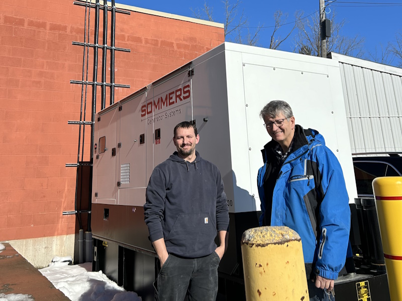 Electrical Generator outside of Foodland with two men.